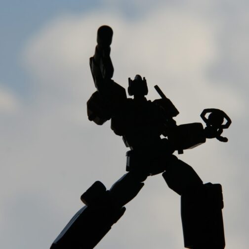 Action figure in shadow against sky background